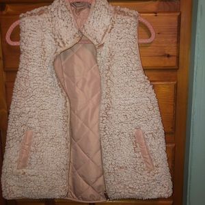 Reversible pink vest with pockets on both sides.